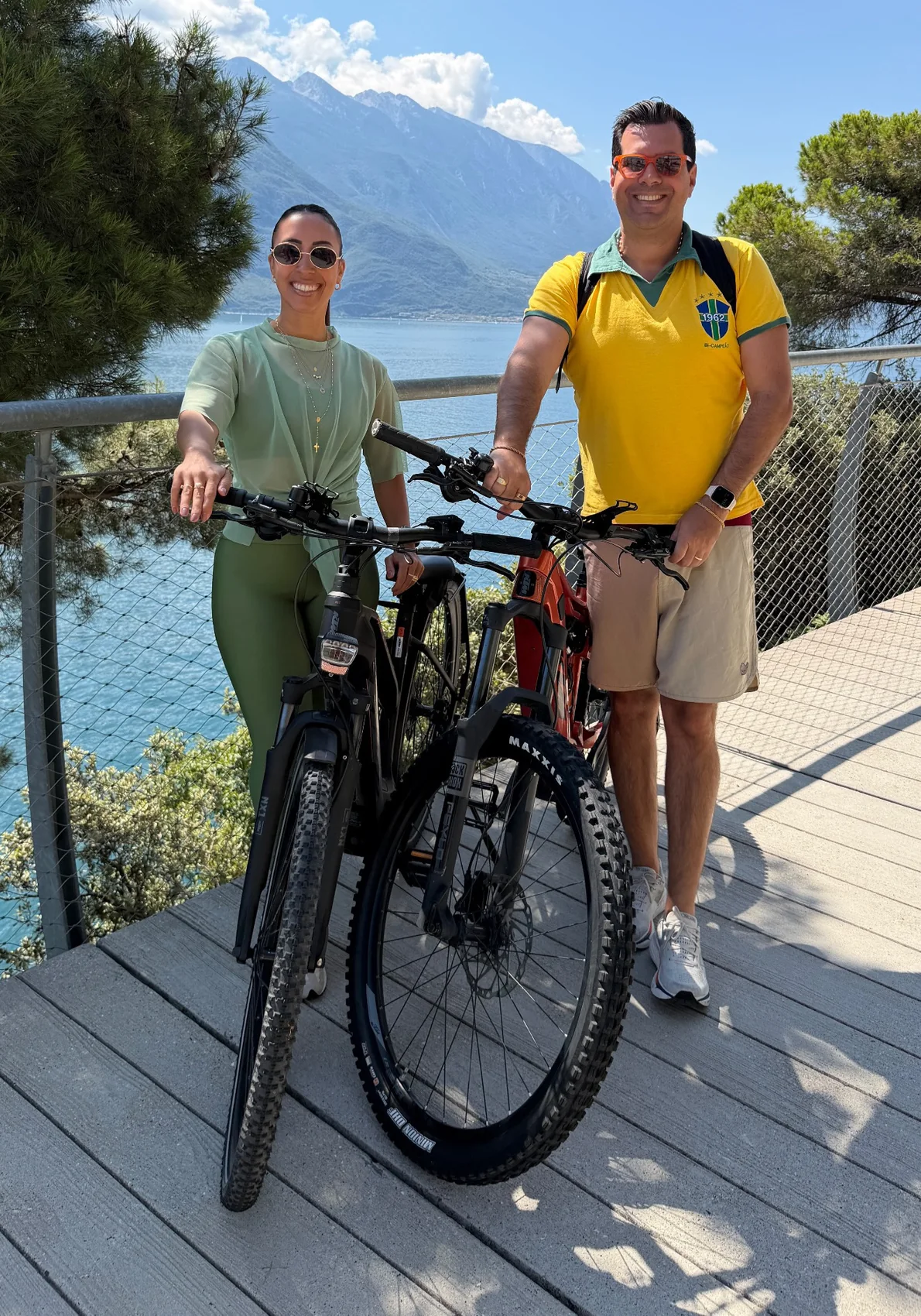 Couple with two e-bikes beside Lake Garda in Limone sul Garda